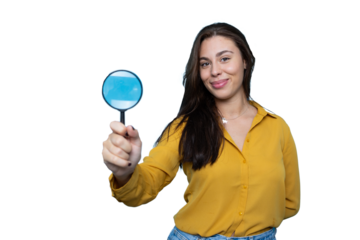 Portrait of a young businesswoman holding a magnifying glass