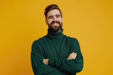 Obraz premium Handsome man in turtleneck sweater smiling with crossed arms.