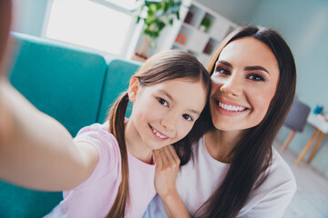 Photo of adorable good mood family recording video taking selfie indoors living room apartment