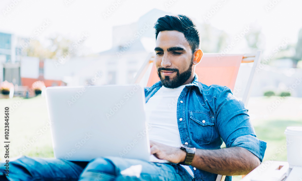 Poster carefree hipster guy taking rest in university campus area with public internet connection enjoying 