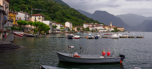 Scenic Lake Como Village With Boats And Hillside