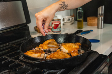 Cooking Braised Chicken Thighs on Tomatoes Action Shot