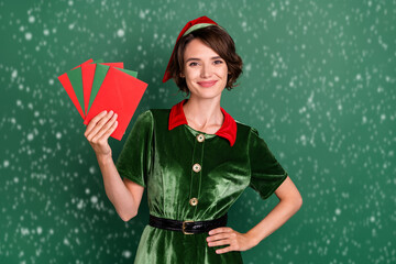 Photo of nice postman helper lady hold fan envelop wear elf costume hat isolated green color...