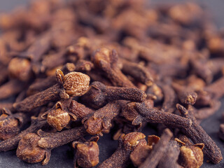 A close-up of aromatic cloves, highlighting the texture and rich color