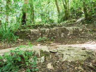 Sheer cliffs frame ancient ruins, reminiscent of past greatness, creating a mystical atmosphere and sense of time