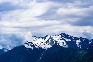 Close-up of mountain peaks adorned with snow caps, reflecting the power and beauty of the wild