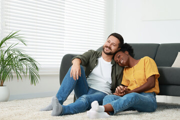Obraz premium International relationships. Lovely couple spending time together on floor at home