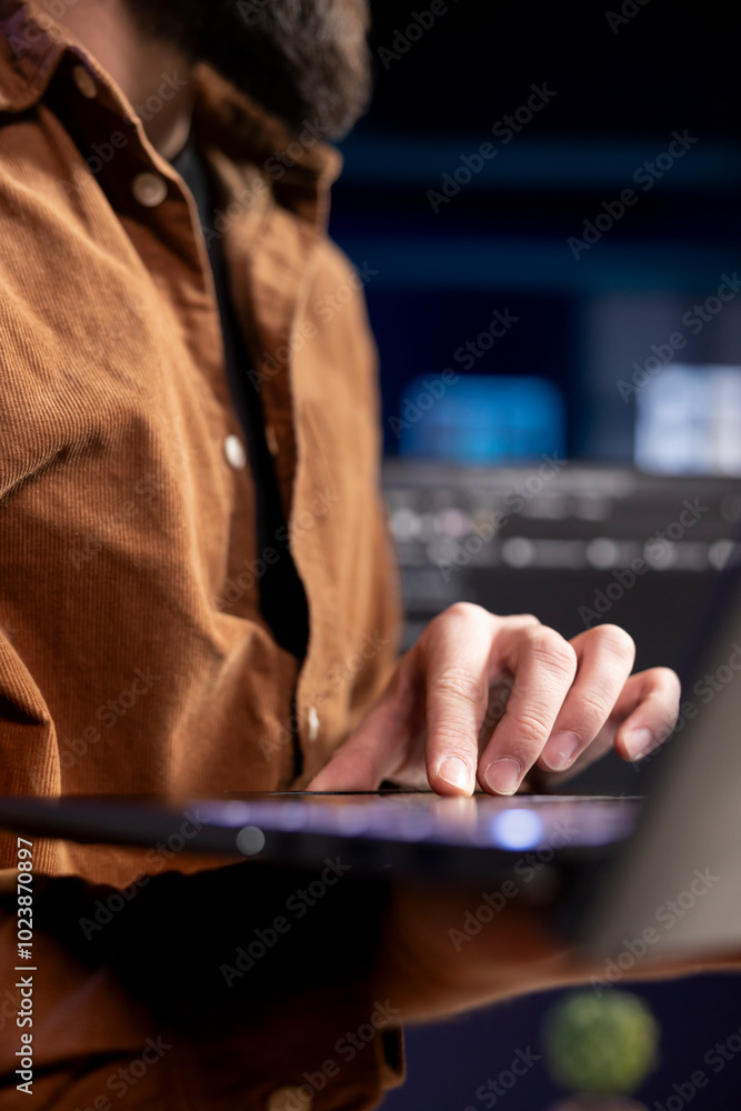 Poster developer at home typing on laptop to fix vulnerabilities in software enabling attackers to compromi