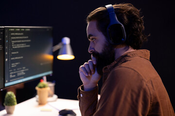 Developer listening music and futureproofing company network from downtimes and unexpected system...