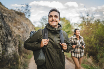 Boyfriend hiker explore scenic forest trail with girlfriend near him