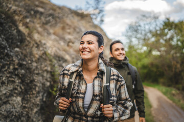 Fototapeta premium girlfriend hiker explore scenic forest trail with boyfriend near her