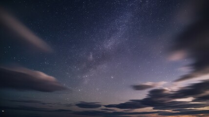 Fototapeta premium A captivating night sky filled with stars and soft clouds, creating a serene and tranquil atmosphere.