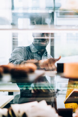 Waiters inspecting cake assortment in cafe