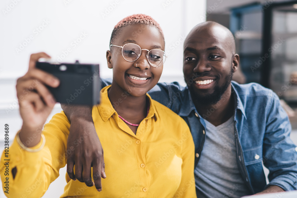 Wall mural relaxed colleagues taking selfie in cafe