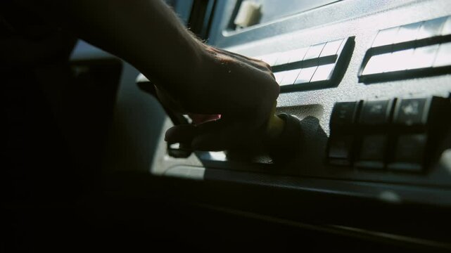 Professional Truck Driver sits in his truck and presses the air brake button