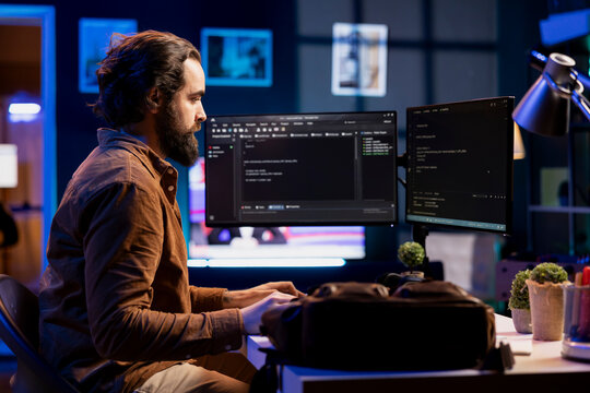 Developer in neon lit apartment implement security measures, protecting company systems and data. System administrator working from home, testing and debugging Javascript code