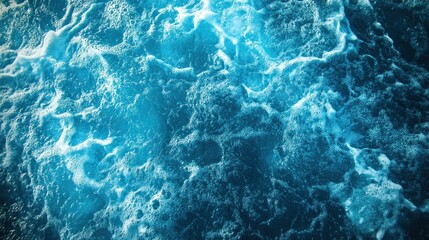 Fototapeta premium Closeup of blue ocean water with white foam.