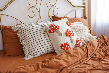 Beautifully styled bed features warm, rich toned bedding and charming decorative pillows with...