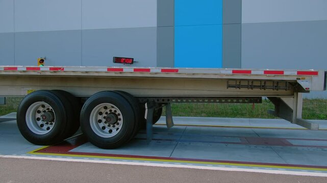 The truck drive into the weighing station on road. Industrial equipment for measuring weight.