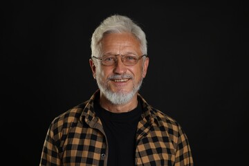 Portrait of senior man on black background