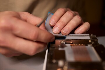 Hand Repairing a Graphics Card through the Application of Thermal Paste for Better Performance