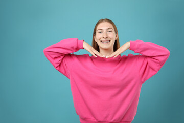 Smiling girl with braces on light blue background