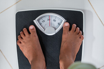 Person Weighing on Bathroom Scale