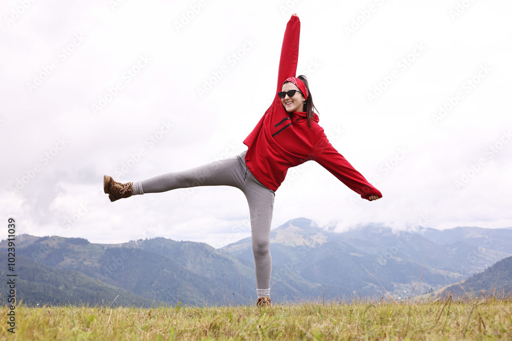 Wall mural Happy young hiker in mountains. Active tourism