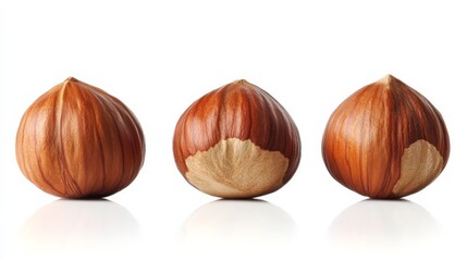 3 ripe hazelnuts in a row on white