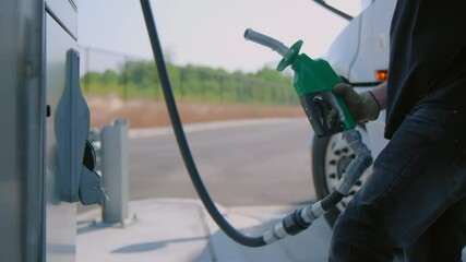 The driver refuels the semi truck. Petrol station with gas pumps. Close up view