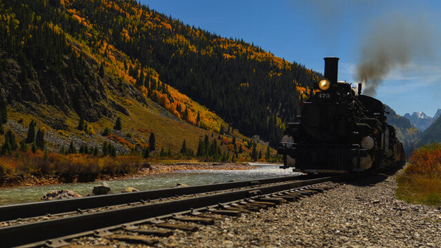 Silverton Durango steam engine train passes by fall colors in Colorado, USA