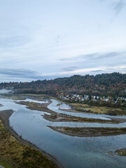 Scenic Aerial View of Serpentine River Flowing Through Lush Green Forests in Mission, British Columbia, Canada