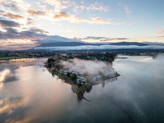 Aerial View of Misty Landscape in Mission, BC with Water Reflections and Mountains