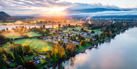 Scenic Aerial View of Mission, BC at Sunrise With Flowing River and Lush Green Landscape
