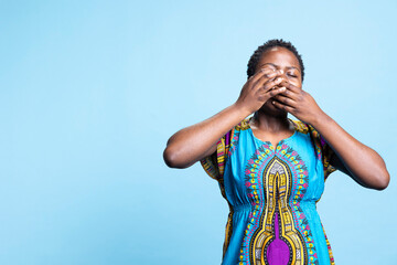 African american woman feeling fatigued in front of camera, yawning and being extremely tired while...