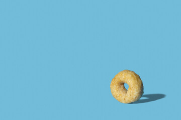 Cheerios cereal loop on blue background with copy space