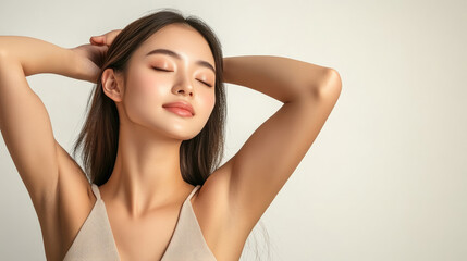 Fototapeta premium A woman with long hair and a white tank top is posing for a picture. She has a relaxed and peaceful expression on her face