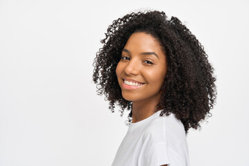 Young curly pretty happy generation z African American woman wearing t-shirt standing isolated on...