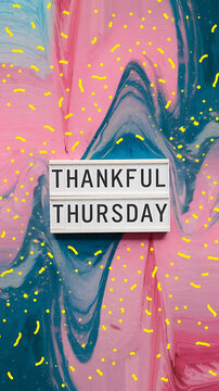 Pink and blue abstract background with lightbox saying Thankful Thursday, positive vibes and gratitude. 
