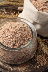 Jar of wheat bran on wooden tray