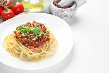 Delicious pasta bolognese on white table. Space for text