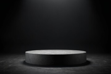 An empty dark grey round stone podium, creating a minimalistic design with no one present for products display