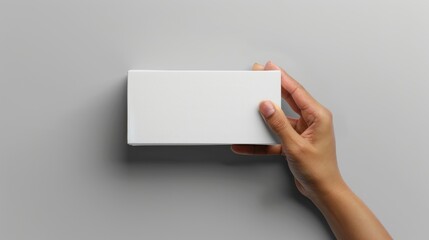 Obraz premium Hand Holding a Blank White Box Mockup