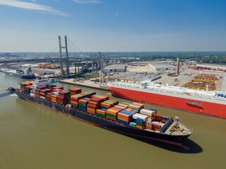 Container ship on the Savannah River passing under the Talmadge Memorial Bridge, Savannah, Georgia,...
