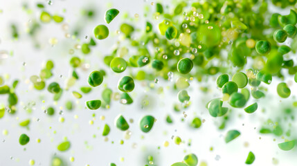 Fototapeta premium A bunch of green peas falls into the salad. A handful of green peas on a white background hovers in the air. A natural product. Food background. The image turns out to be light and airy