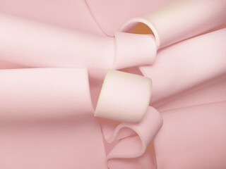 pieces of thin pink foam sponge. a pile of material rolled in a spiral shape