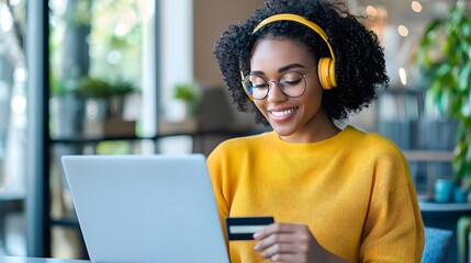 African American woman using a laptop for online shopping credit card in hand enjoying discounts and sales while wearing headphones in a digital tone with an analogous color scheme