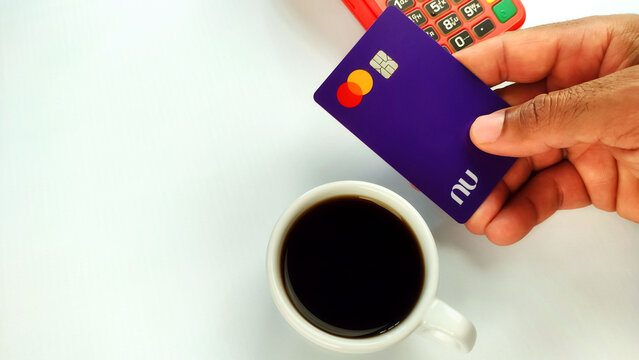 Paying for coffee using visa nubank credit card with copy space. Itabira - Brazil. October 08, 2024