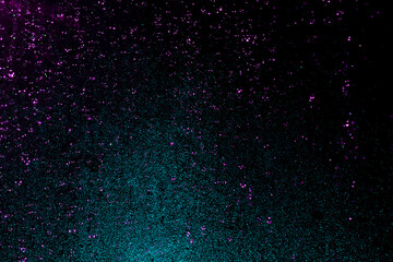 Black dark pink purple orange red shiny glitter abstract background with space. Twinkling glow...