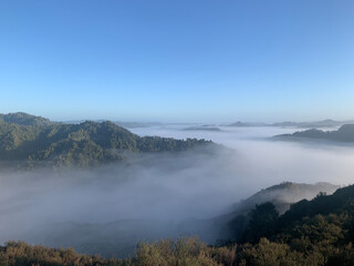 early morning fog through hills